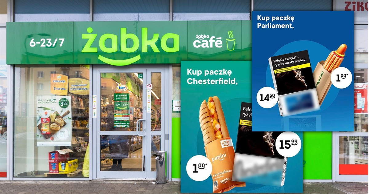 Kasjer w sklepie Żabka, podający klientowi jednocześnie hot-doga i e-papierosa jednorazowego, z wyraźnym brakiem zaangażowania czy wiedzy na temat sprzedawanego produktu vape.
